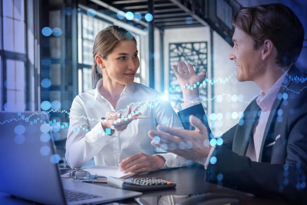 Two banking executives discussing digital transformation strategy in an office