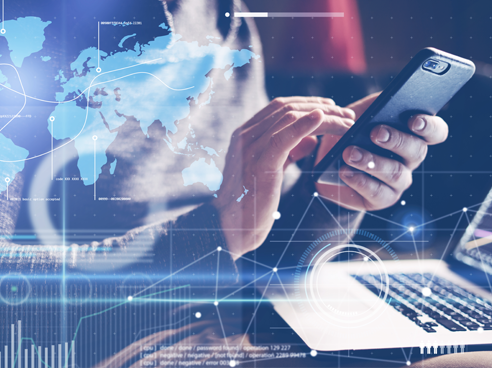 Woman using their smartphone while sitting in front of their laptop with a data analytics overlay