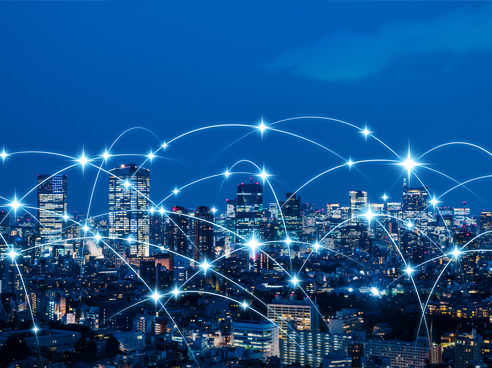 City skyline at night with internet connection lines connecting each building