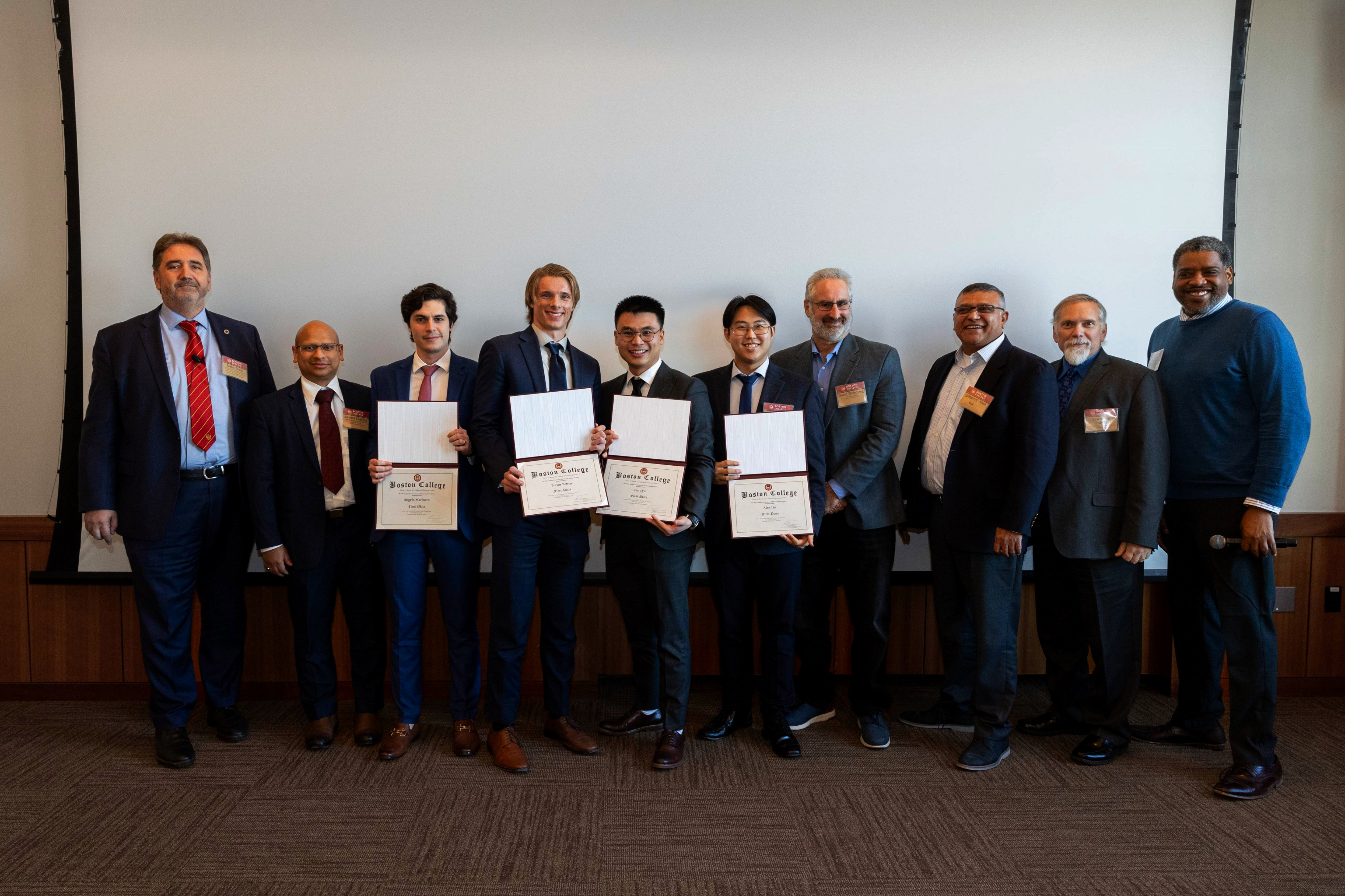 A group of individuals poses for a photo, with several holding certificates after being awarded  $3000 in prizes from Myridius’ representatives.