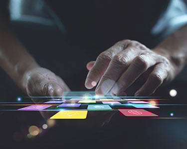 Man-using-smartphone-with-colourful-mobile-apps-on-virtual-screen
