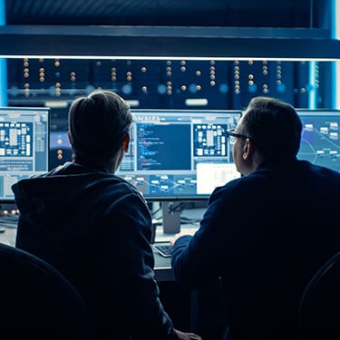 Two Professional IT Programmers Discussing Data Network Architecture Design