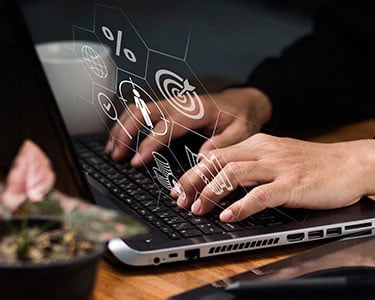 customer centric tactics Working on a computer to analyze prospective customers