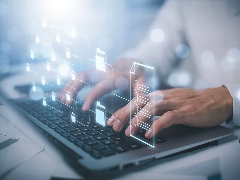 Businessman-working-on-laptop-with-virtual-screen