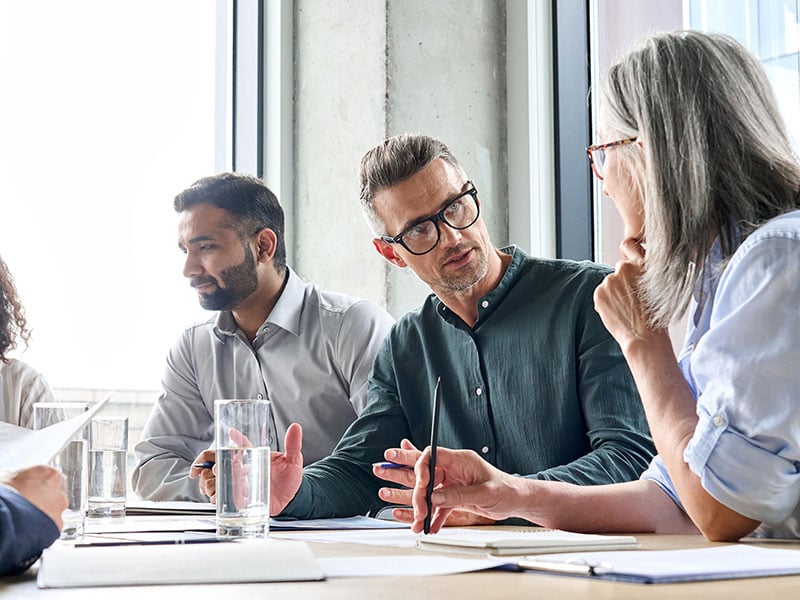 Diverse-business-people-partners-group-negotiating-at-boardroom-meeting