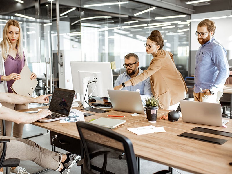 Group-of-diverse-colleagues-working-on-the-computers-in-the-modern-office-or-coworking-space