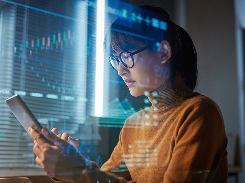 Young-woman-in-eyeglasses-projecting-the-program-on-digital-tablet-during-her-work-at-office