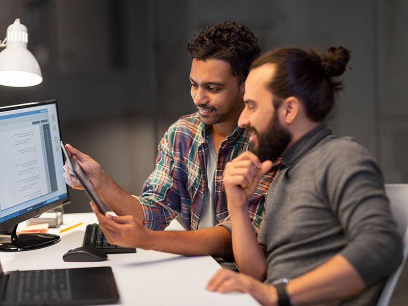 creative-team-with-tablet-pc-computer-working-together-late-at-night-office